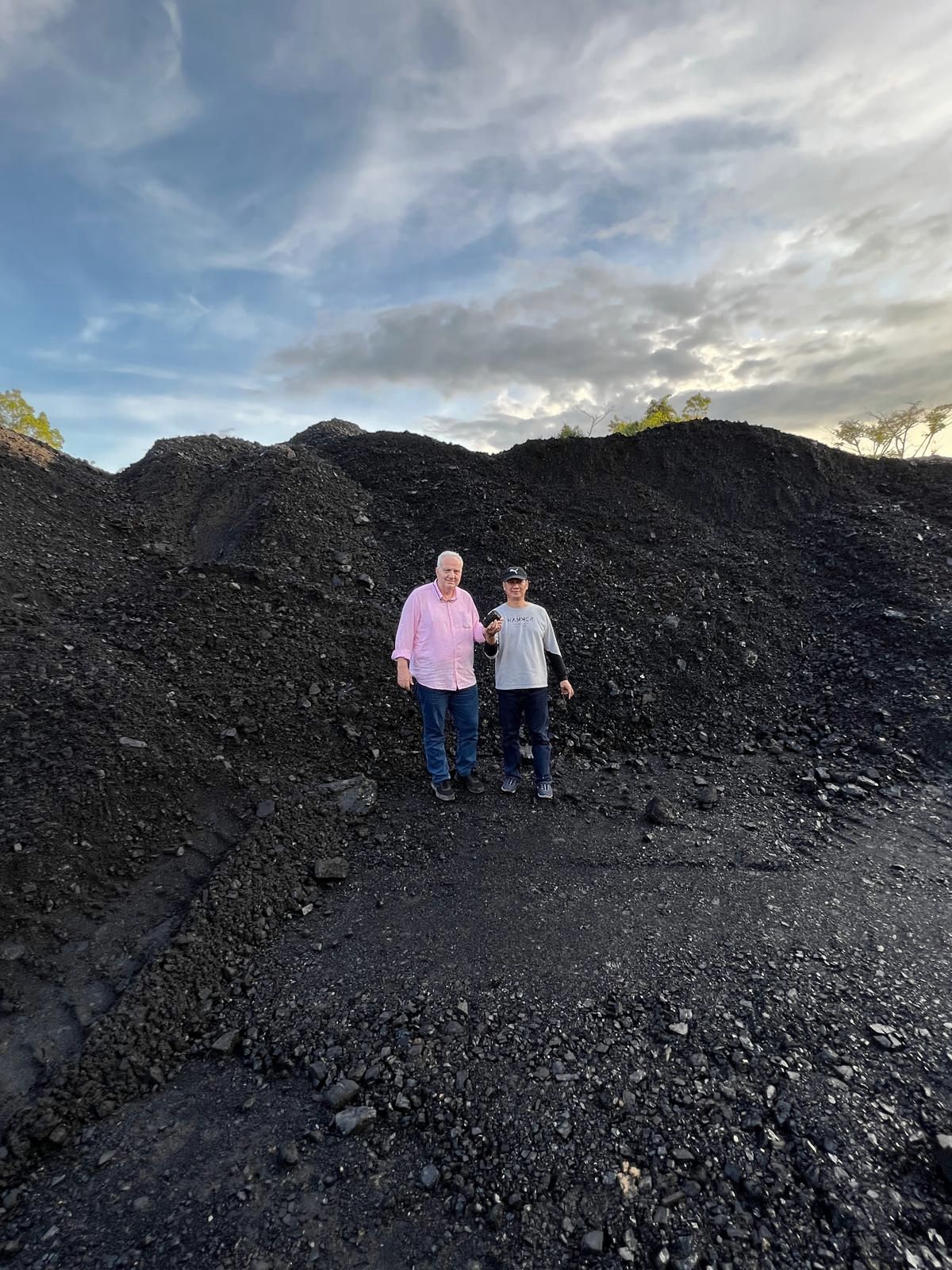TEM Global executive at a coal stockpile with mine operator